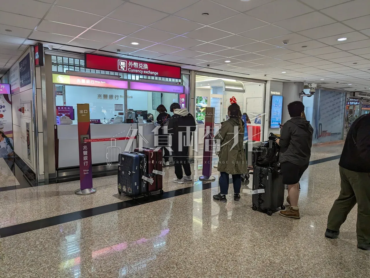 桃園空港の兆豊銀行 Currency Exchange カウンターに旅行客が並ぶ様子